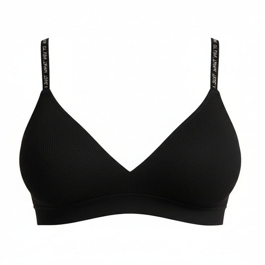 Woman wearing a black bra against a gray background