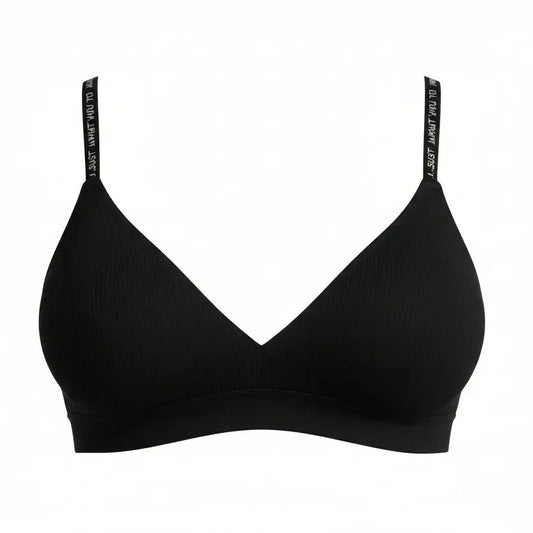 Woman wearing a black bra against a gray background