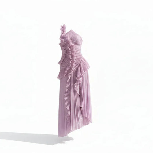Woman wearing a one-shoulder lavender dress with ruffled details on a white background