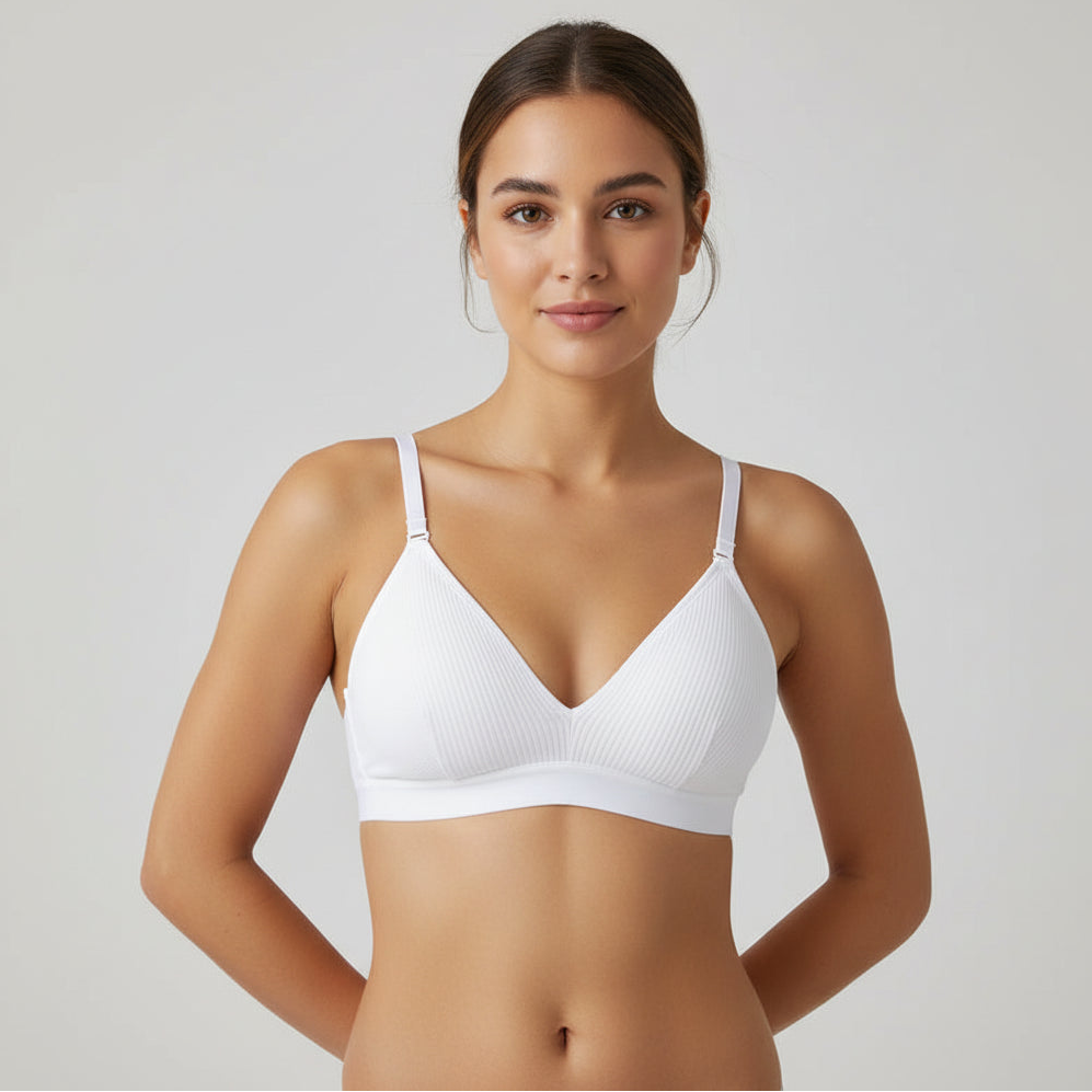 White bra on a wooden hanger with a white cup and saucer in the background
