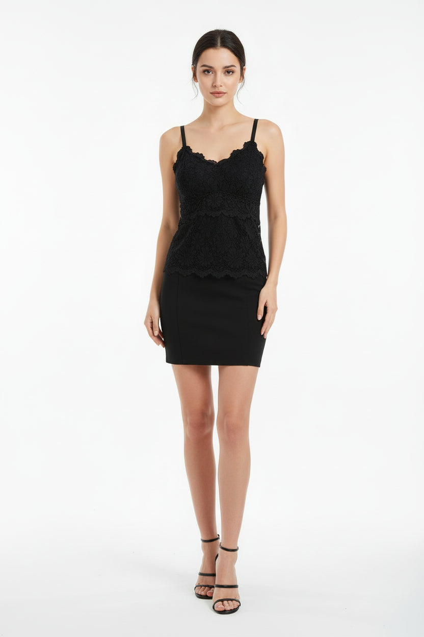 Black lace camisole on a beige surface with a magazine underneath