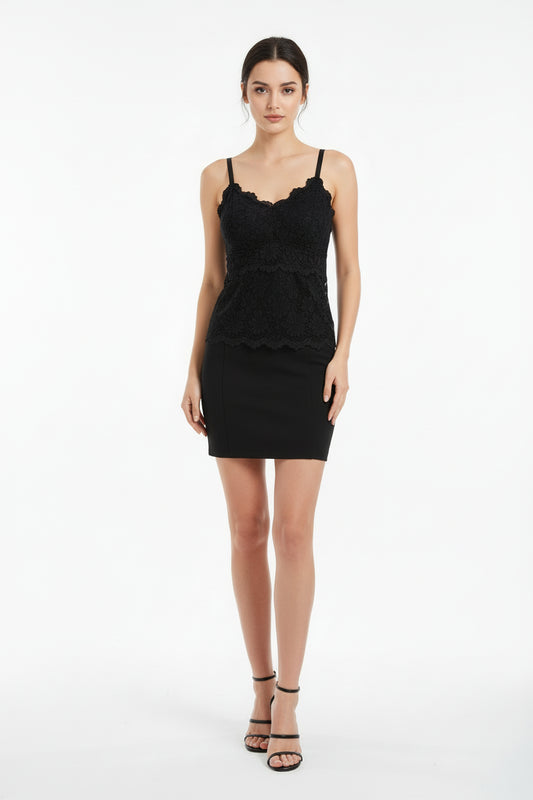 Black lace camisole on a beige surface with a magazine underneath