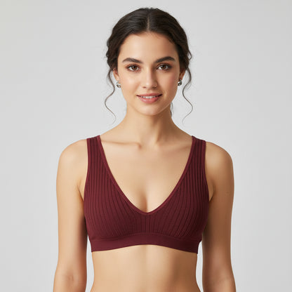 Maroon ribbed bralette on a white background with small decorative elements
