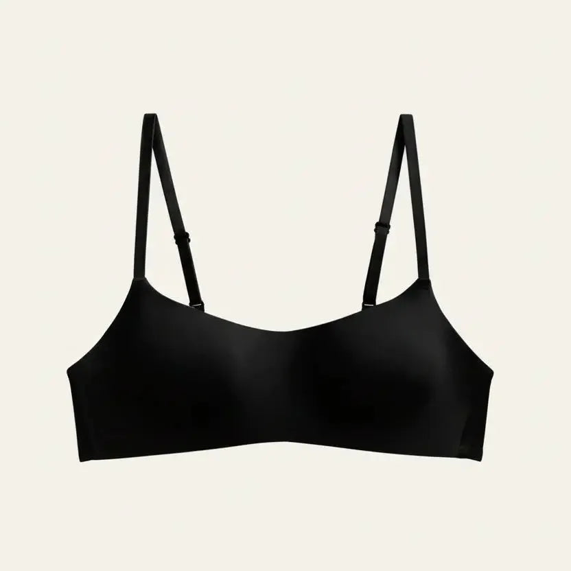 Black bra with thin straps on a light gray background