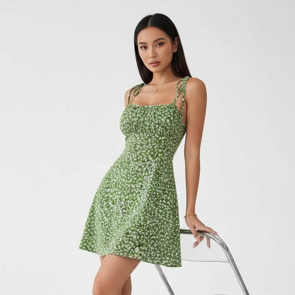 Woman wearing a green floral dress in an indoor setting