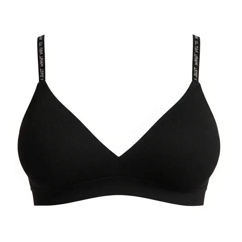 Woman wearing a black bra against a gray background