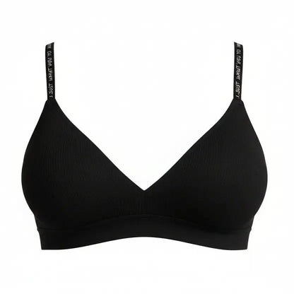 Woman wearing a black bra against a gray background