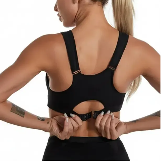 Person wearing a black sports bra with a neutral background