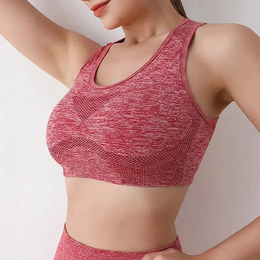 Red sports bra worn by a person on a plain background
