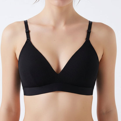 Black bra on a wooden stick with a white cup and saucer in the background