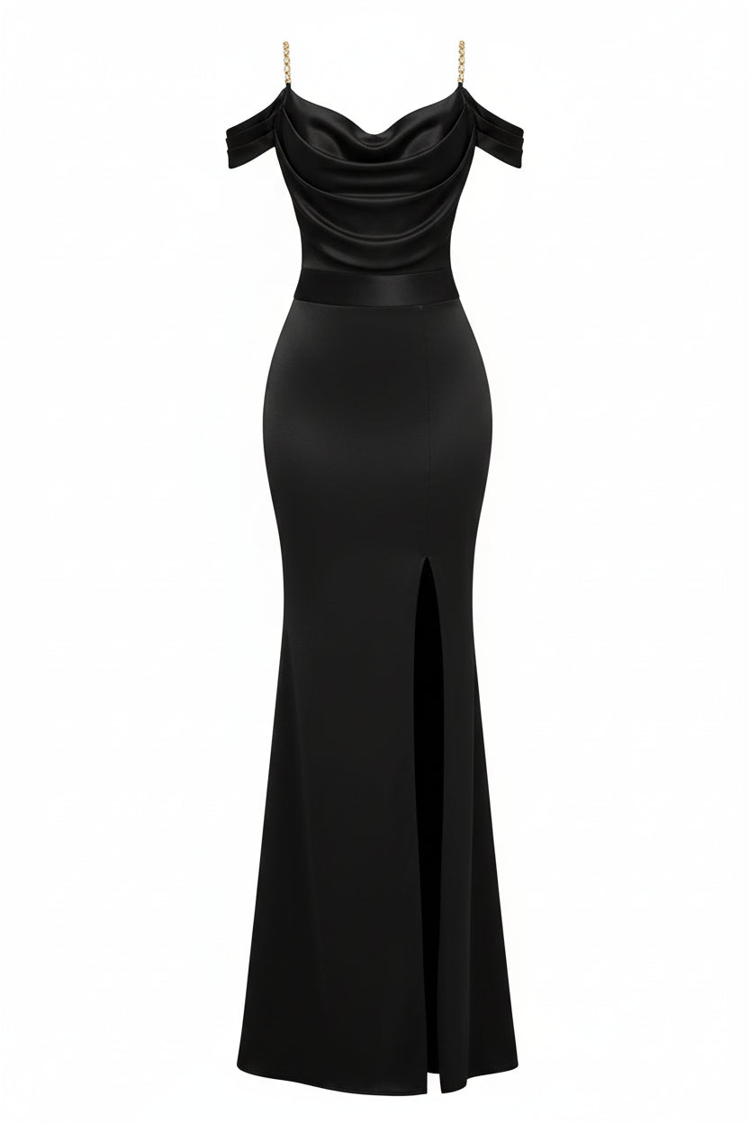 Woman in a black off-shoulder evening gown with a high slit, holding a gold clutch in a bright room.