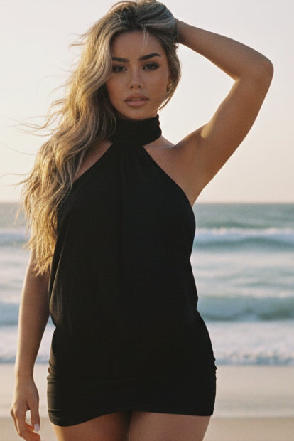 Woman wearing a black dress with a cutout design, standing against a neutral background.