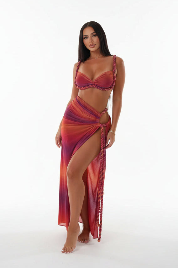 Woman in a red and purple dress on a yacht with a marina background