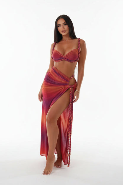 Woman in a red and purple dress on a yacht with a marina background