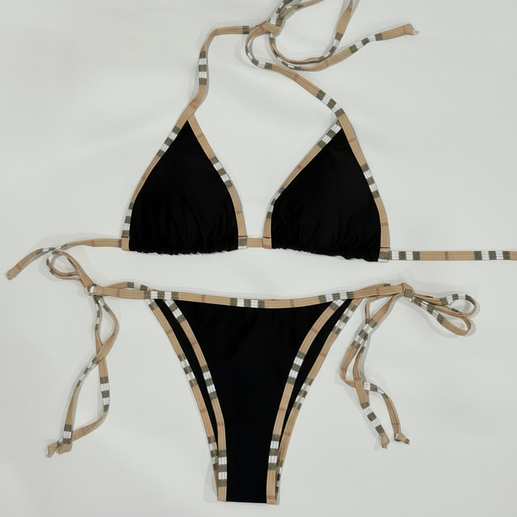 Black bikini with beige and white patterned straps on a white background